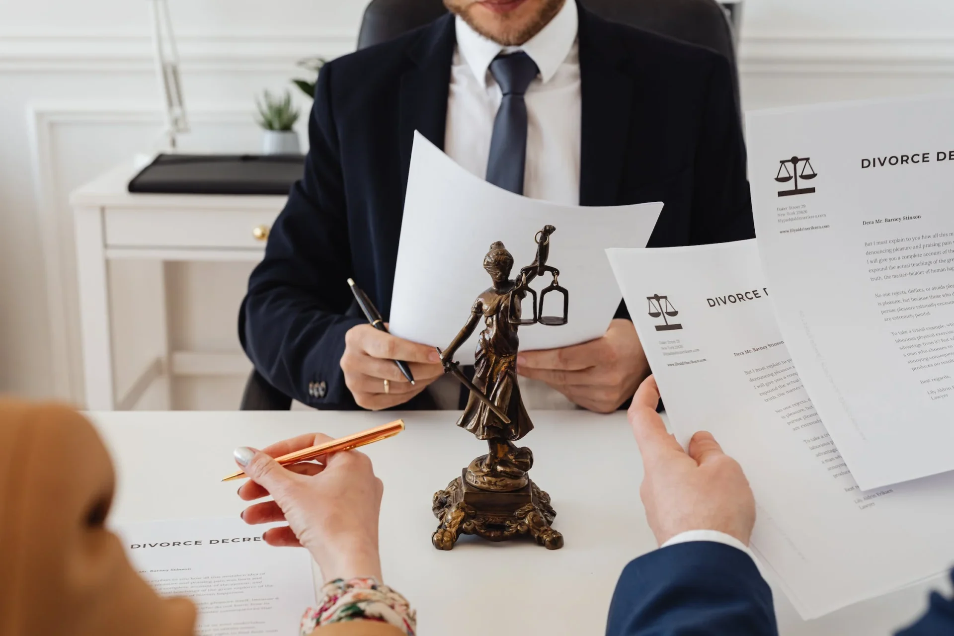 pexels-photo-7876050 - DumpADate.com A man in suit and tie sitting at table with papers.